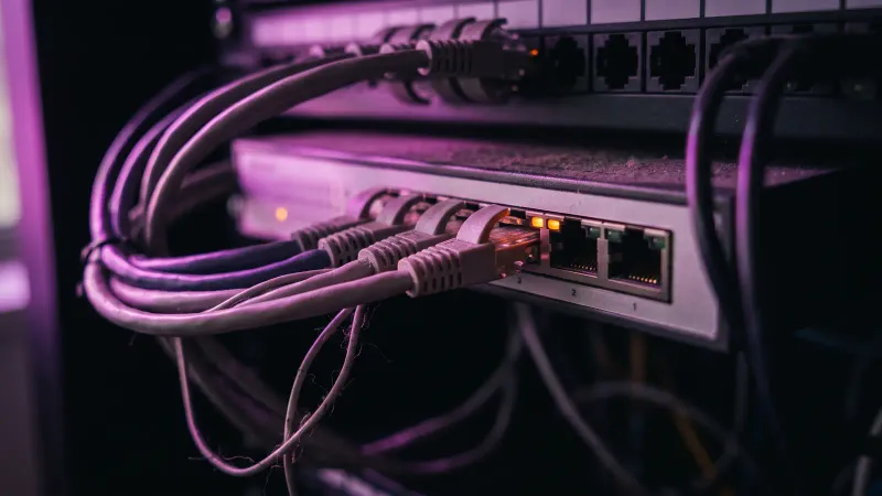 Macro of a network switch with patch cables in a shop office rack, a picture of manufacturing data readiness for AI