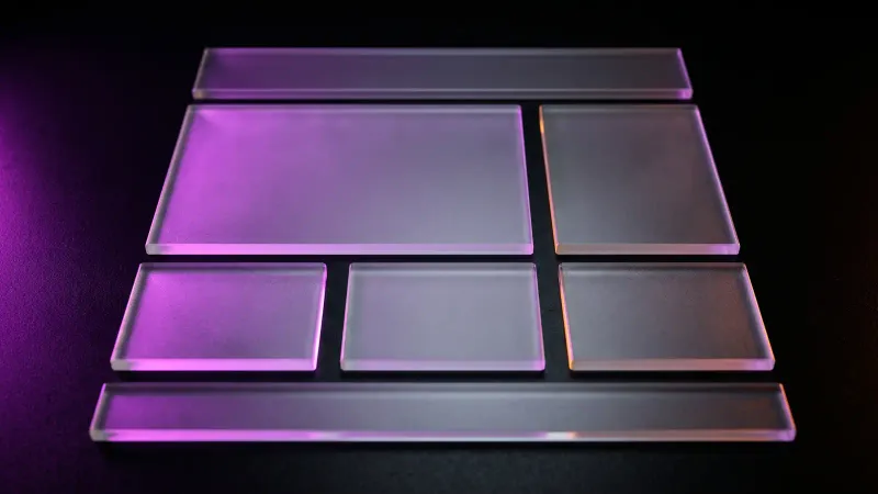 Eight frosted glass tiles arranged like a web page layout, the pieces of work in a Massachusetts small business website