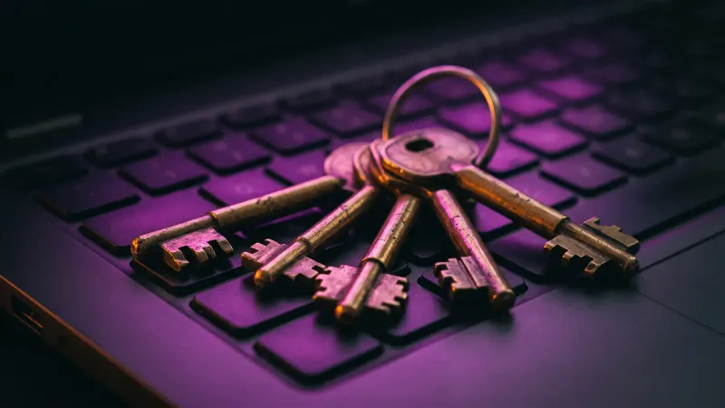 Brass keys on a laptop keyboard, a metaphor for owning your Massachusetts small business website domain and logins