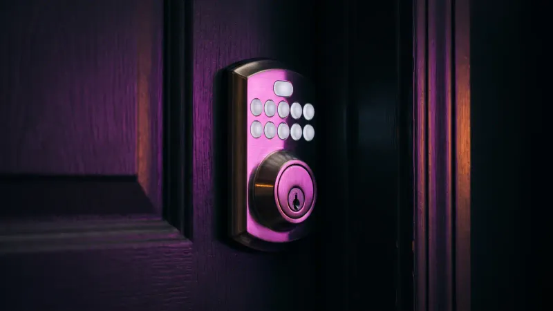 Close up of a smart lock keypad glowing on an apartment door, smart lock security for Worcester rental properties
